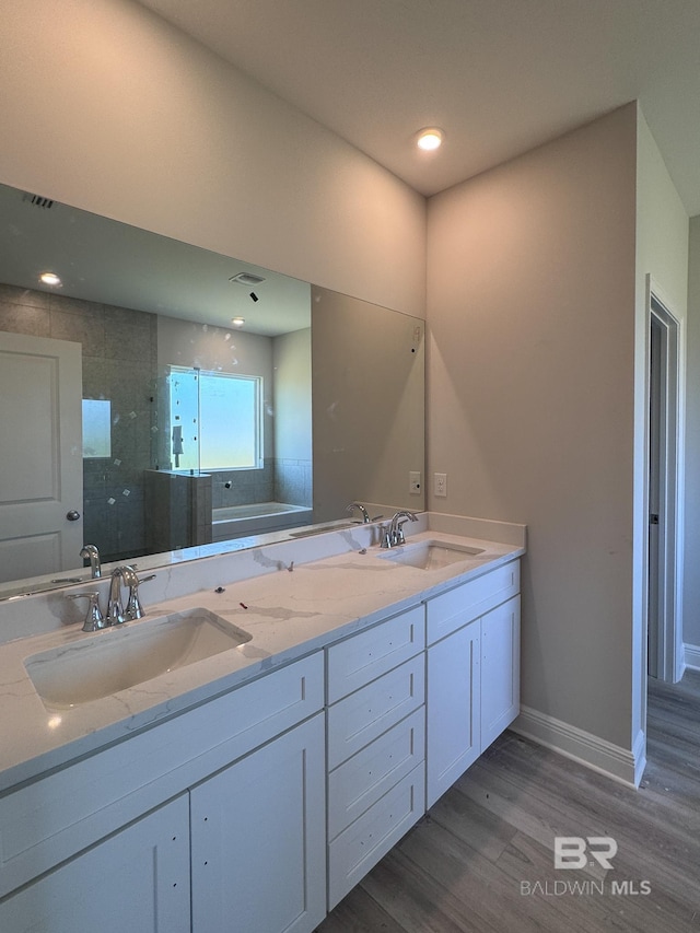 23850 Shadowridge Dr, Daphne, AL 36526 - bathroom with double vanity, wood finished floors, a bath, baseboards, and a shower