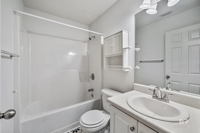 full bathroom with vanity, shower / tub combination, toilet, and a textured ceiling