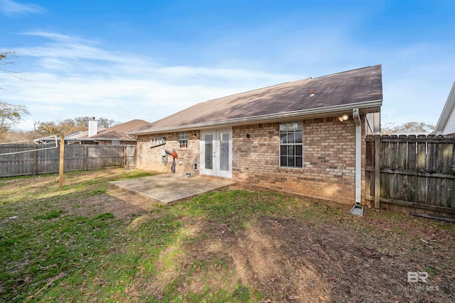 rear view of property with french doors and a patio area