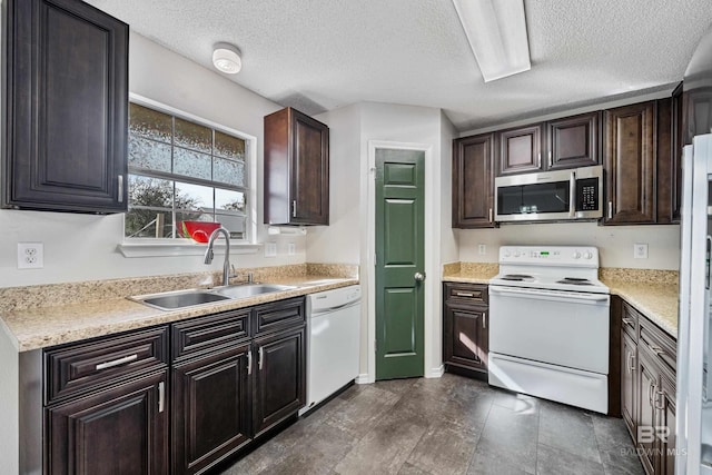 kitchen featuring dark brown cabinets, sink, a textured ceiling, and white appliances