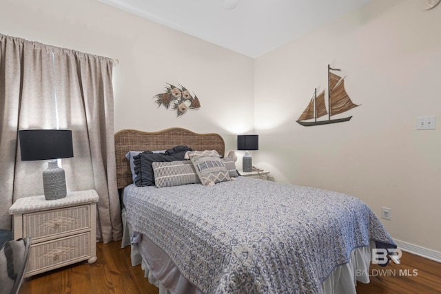 bedroom featuring dark wood-style flooring and baseboards