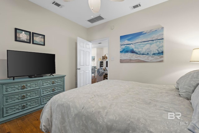 bedroom featuring ceiling fan, visible vents, and dark wood-type flooring