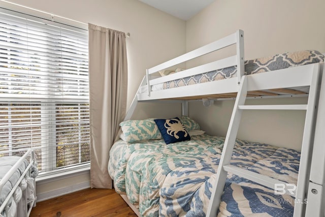 bedroom with baseboards and wood finished floors