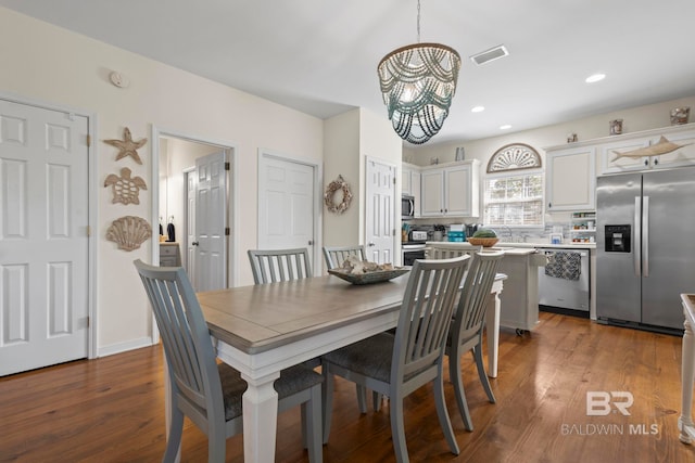 dining room with a chandelier, recessed lighting, dark wood-style flooring, and visible vents