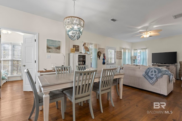 dining space featuring a wealth of natural light, visible vents, and dark wood-style flooring