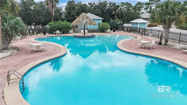 pool featuring a patio area, fence, and a gazebo