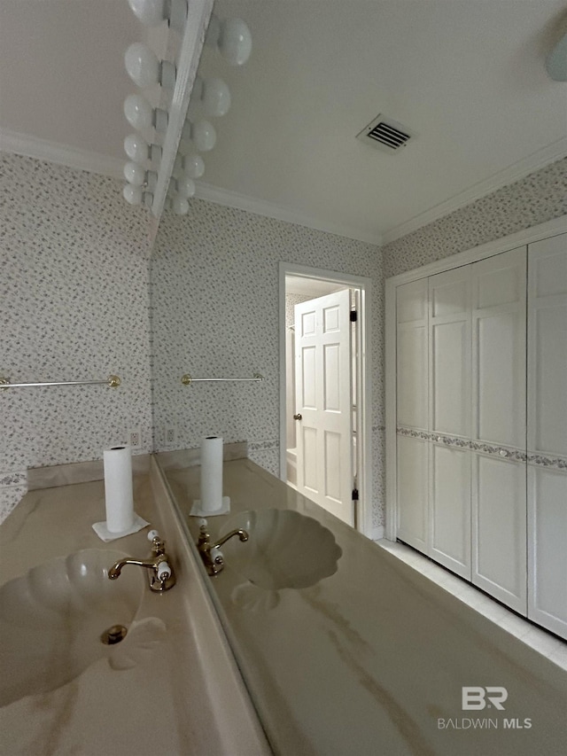 bathroom with visible vents, ornamental molding, vanity, and wallpapered walls