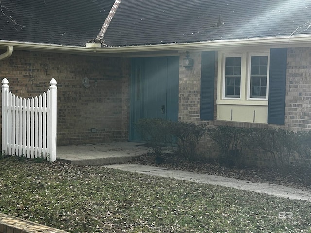 view of side of home featuring brick siding