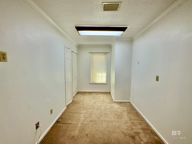 interior space featuring crown molding, baseboards, visible vents, and a textured ceiling