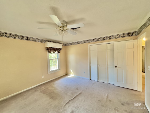 unfurnished bedroom featuring a closet, baseboards, light colored carpet, and a ceiling fan