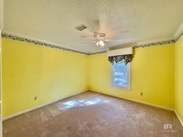 carpeted empty room featuring visible vents, a textured ceiling, crown molding, baseboards, and ceiling fan