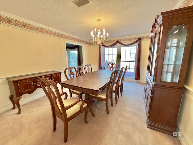 dining space featuring light colored carpet, a chandelier, and ornamental molding