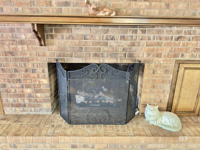 room details featuring a brick fireplace