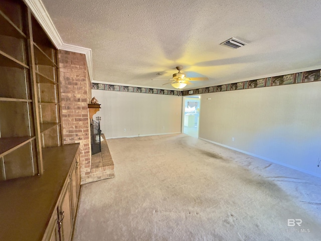 unfurnished living room featuring visible vents, ceiling fan, a textured ceiling, a brick fireplace, and light colored carpet