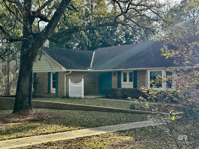 ranch-style house with brick siding and fence