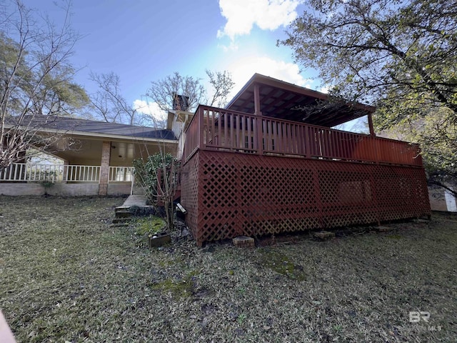 back of house featuring a chimney