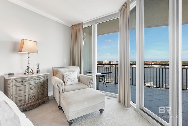 sitting room with ornamental molding, floor to ceiling windows, a water view, and light carpet