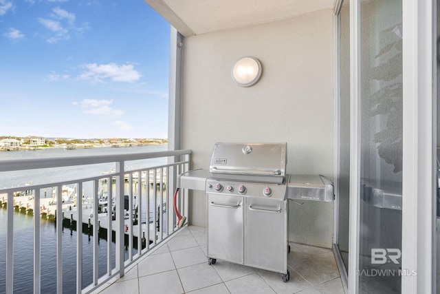 balcony with a water view and area for grilling