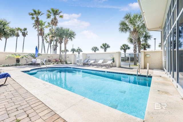 pool featuring a patio area and fence