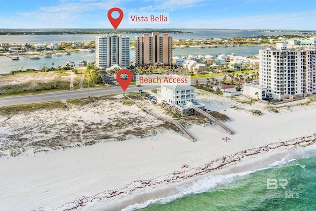 drone / aerial view with a water view and a view of the beach