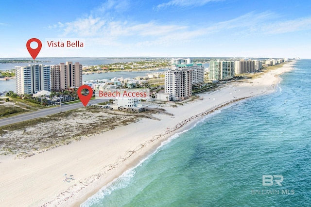 birds eye view of property with a water view and a view of the beach