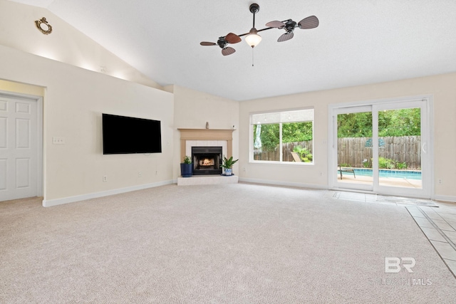 25391 Monarch Ct, Loxley, AL 36551 - unfurnished living room with a ceiling fan, baseboards, vaulted ceiling, healthy amount of natural light, and carpet