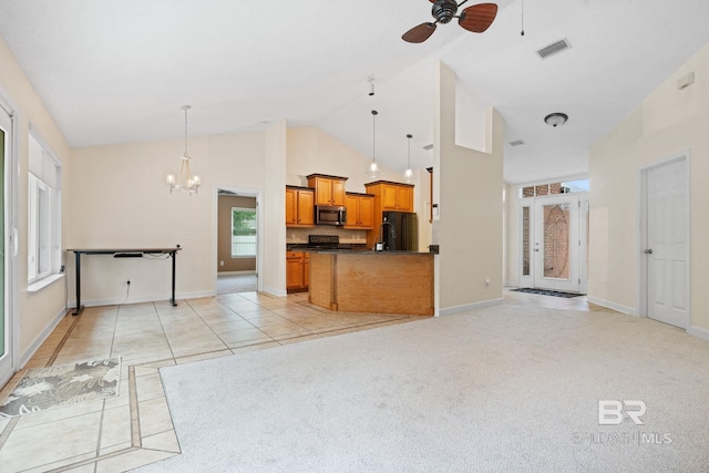 25391 Monarch Ct, Loxley, AL 36551 - kitchen with black appliances, high vaulted ceiling, dark countertops, brown cabinetry, and a chandelier