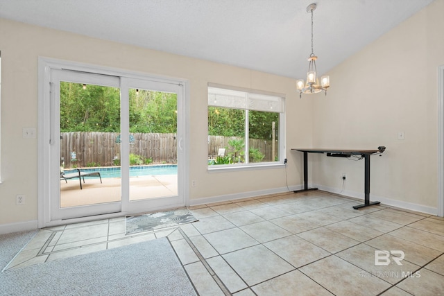25391 Monarch Ct, Loxley, AL 36551 - unfurnished dining area featuring a chandelier, tile patterned floors, baseboards, and lofted ceiling