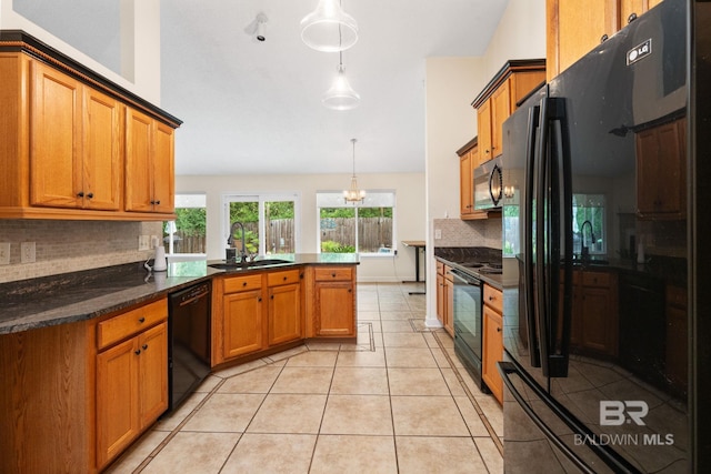 25391 Monarch Ct, Loxley, AL 36551 - kitchen featuring black appliances, a sink, brown cabinets, tasteful backsplash, and a peninsula