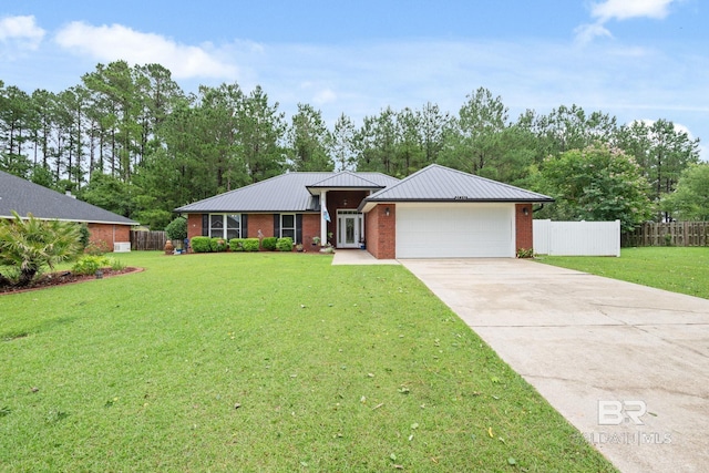 25391 Monarch Ct, Loxley, AL 36551 - ranch-style home featuring concrete driveway, an attached garage, brick siding, and metal roof
