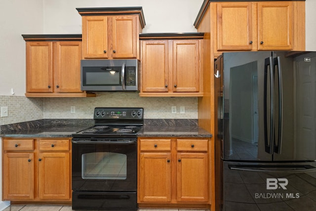 25391 Monarch Ct, Loxley, AL 36551 - kitchen featuring black appliances, light tile patterned floors, and dark stone countertops