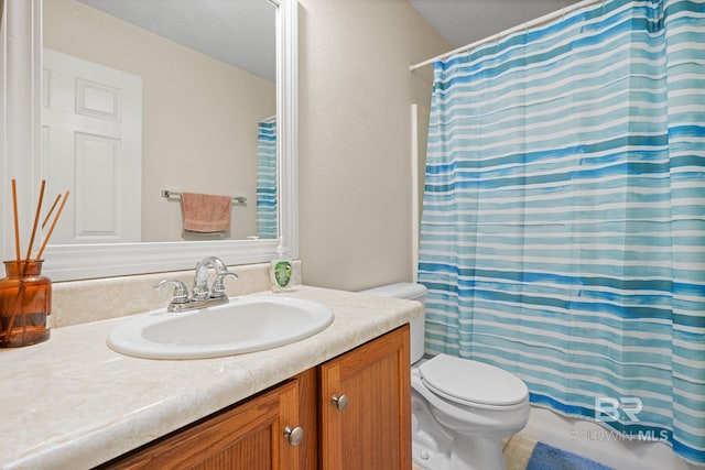 25391 Monarch Ct, Loxley, AL 36551 - bathroom with toilet, vanity, a textured ceiling, and a shower with curtain