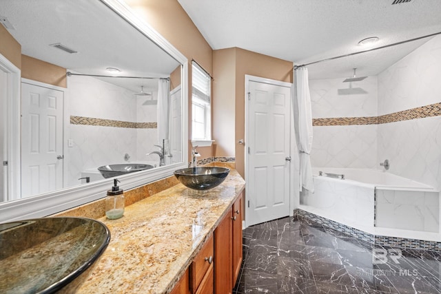 25391 Monarch Ct, Loxley, AL 36551 - full bathroom featuring marble tiled flooring, double vanity, a combined bath / shower with rainfall shower, and a textured ceiling