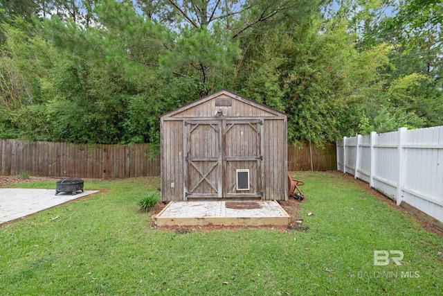 25391 Monarch Ct, Loxley, AL 36551 - view of shed with an outdoor fire pit
