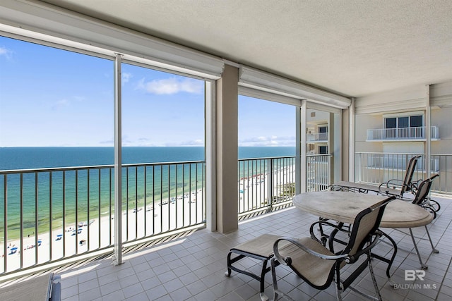 24900 Perdido Beach Blvd Unit 1506, Orange Beach, AL 36561 - sunroom featuring a water view and a beach view