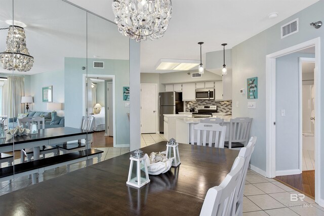 24900 Perdido Beach Blvd Unit 1506, Orange Beach, AL 36561 - dining space featuring light tile patterned floors and a notable chandelier