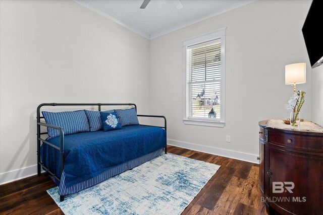bedroom featuring baseboards, ornamental molding, wood finished floors, and a ceiling fan