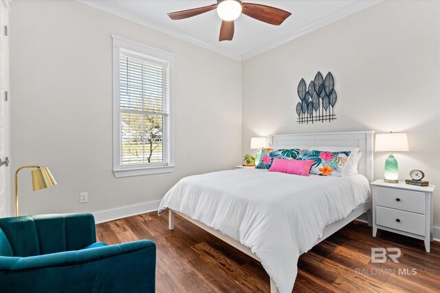bedroom featuring baseboards, ornamental molding, wood finished floors, and ceiling fan