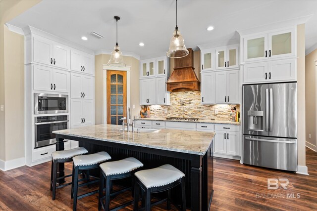 kitchen with decorative backsplash, visible vents, dark wood finished floors, appliances with stainless steel finishes, and custom range hood