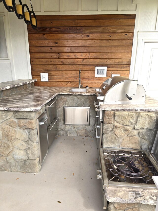 view of patio with an outdoor kitchen and a sink