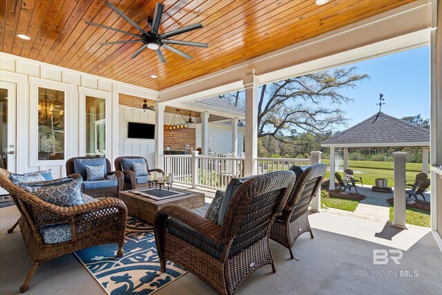 view of patio with an outdoor living space with a fire pit, a gazebo, and ceiling fan