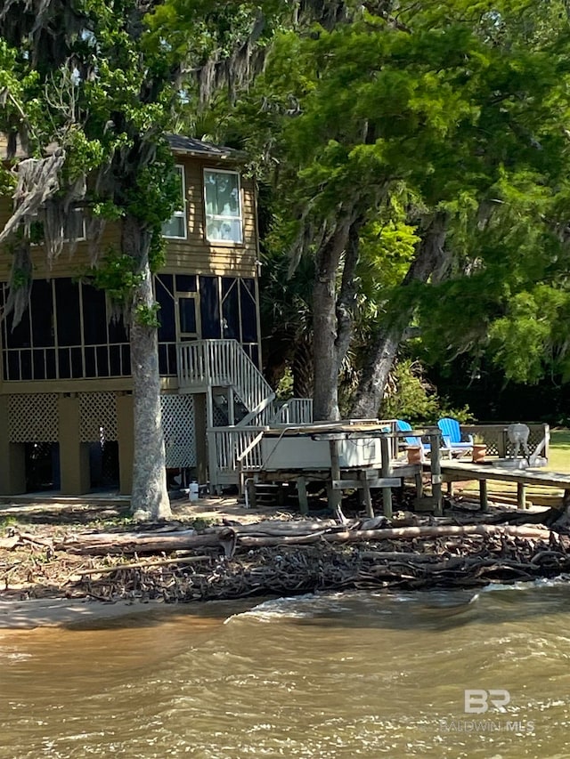 back of property with a water view