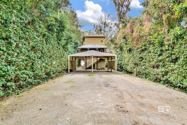 back of property with a detached carport