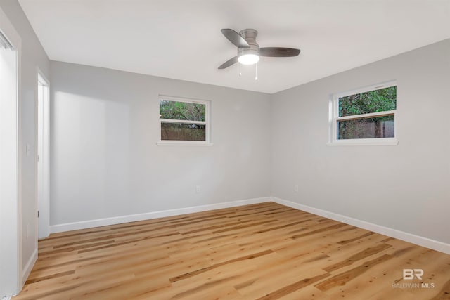 unfurnished room featuring ceiling fan, light wood-type flooring, and plenty of natural light