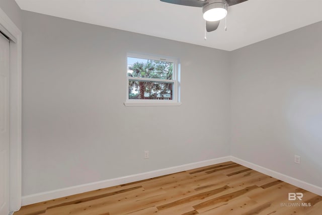 empty room with hardwood / wood-style floors and ceiling fan