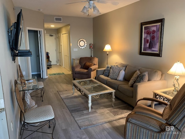 living room with light wood-type flooring and ceiling fan