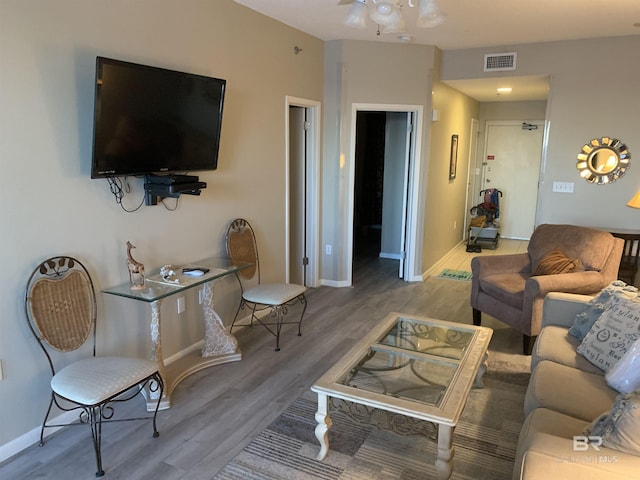 living room with hardwood / wood-style floors and ceiling fan