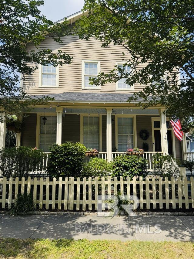 54 S Catherine St, Mobile, AL 36604 - view of front of home featuring covered porch and a fenced front yard