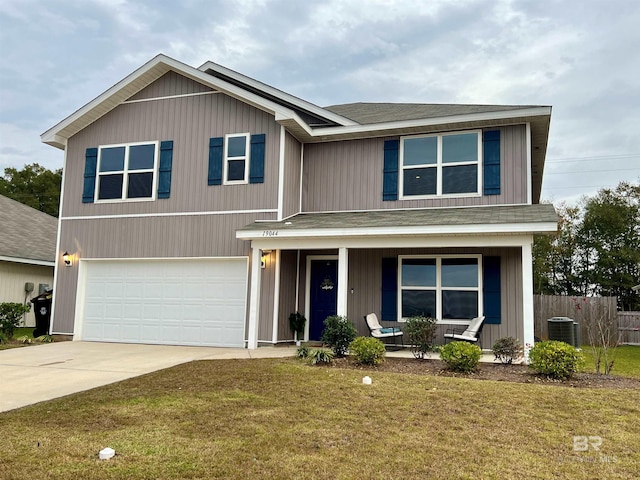 view of front of house featuring a front yard, central AC, and a garage