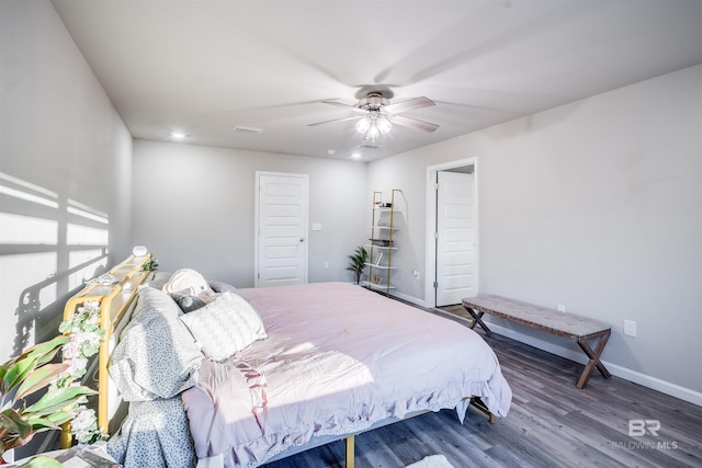 bedroom with ceiling fan and dark wood-type flooring